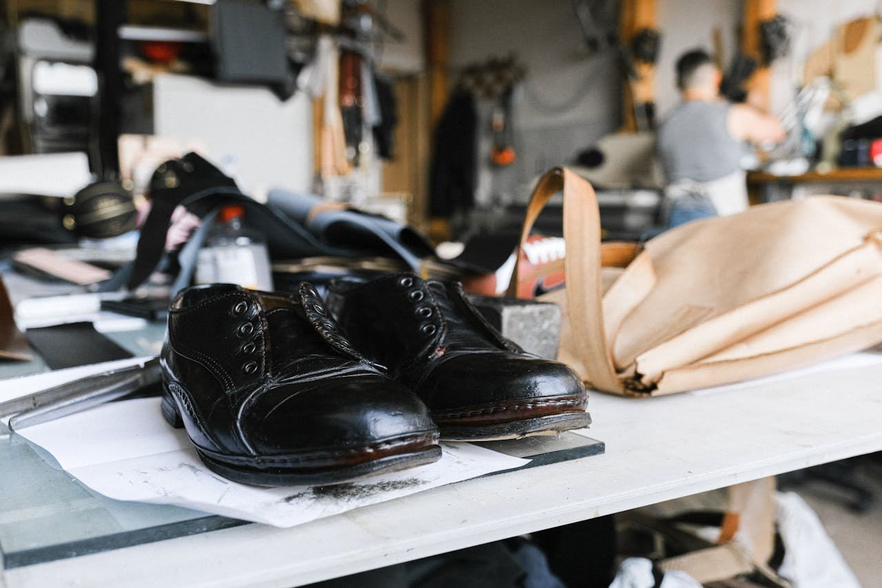 Close-up of handcrafted leather shoes resting on a craftsman's workbench.