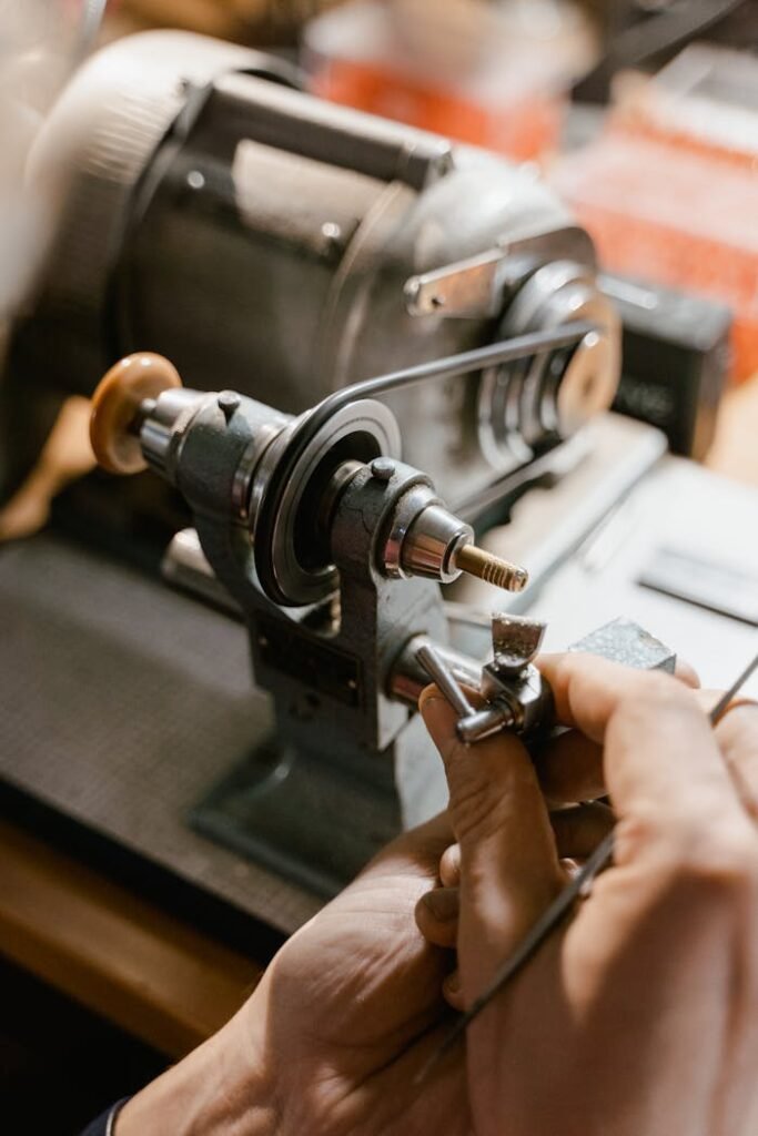 pexels-photo-8327969 Watchmaker uses lathe in meticulous precision work, showcasing craftsmanship and detail.