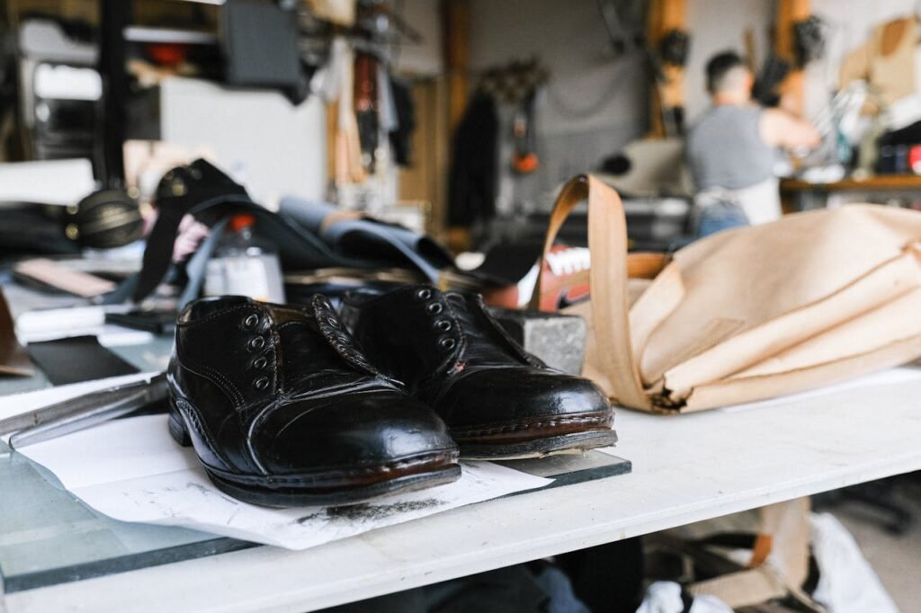 zipwp-image-5894239 Close-up of handcrafted leather shoes resting on a craftsman's workbench.